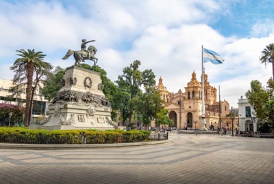 The Argentinian flag flying in a city.