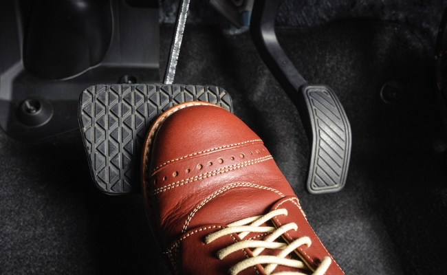 Pressing foot on brake pedal